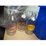 Approximately 20 old milk bottles with advertising