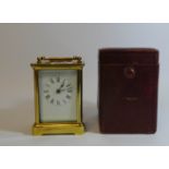 French gilt brass carriage clock with a leather travelling case,