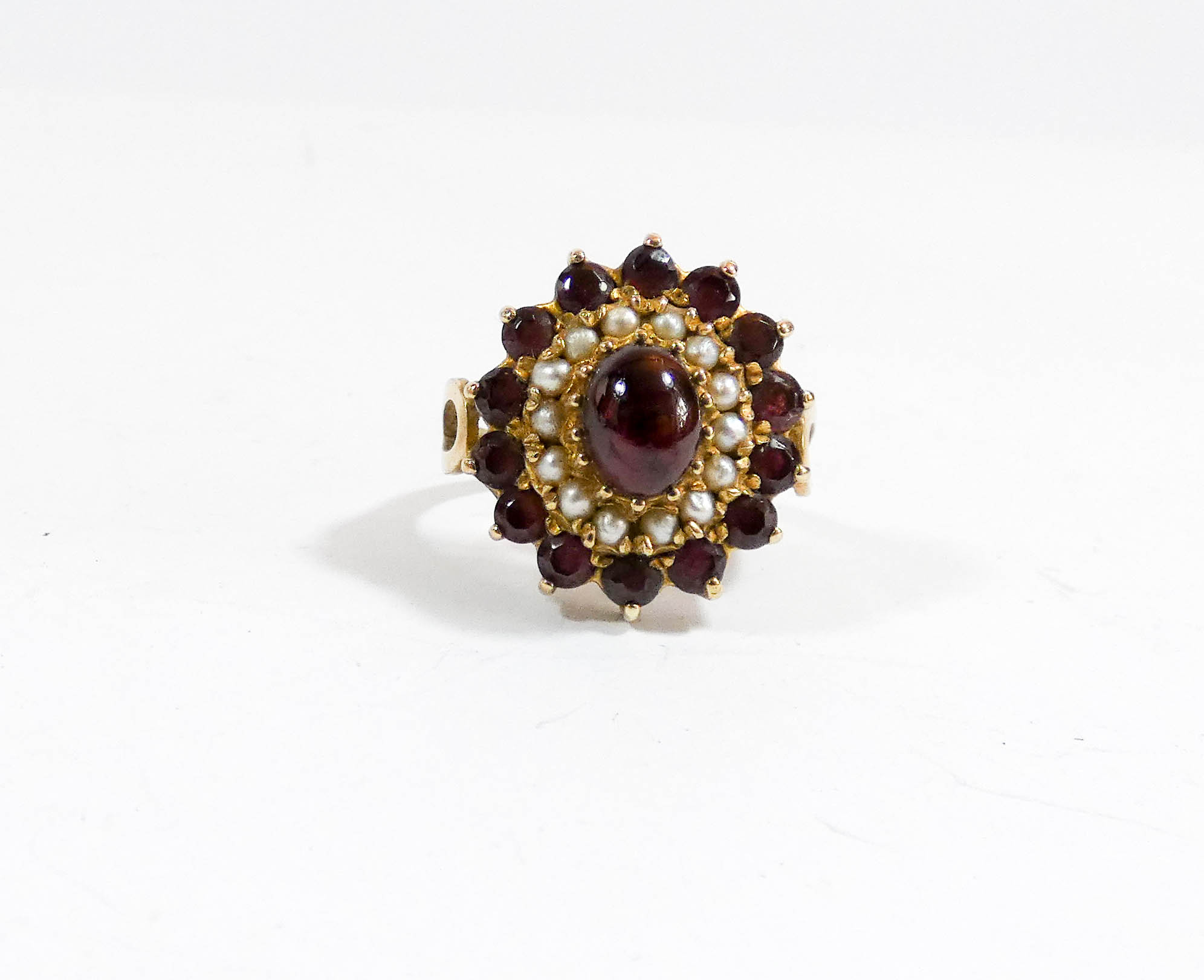 A 9ct gold garnet and seed pearl oval cluster cocktail ring,