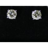 A pair of 18ct white gold mounted diamond stud earrings each set with a single brilliant cut