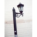 An approximately 8" tall electric black painted metal lantern style outdoor lamppost