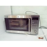 A Sharp microwave oven in a stainless steel case