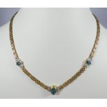 18ct yellow gold modern necklace, set with diamonds and blue topaz, 19 grams, hallmarked.