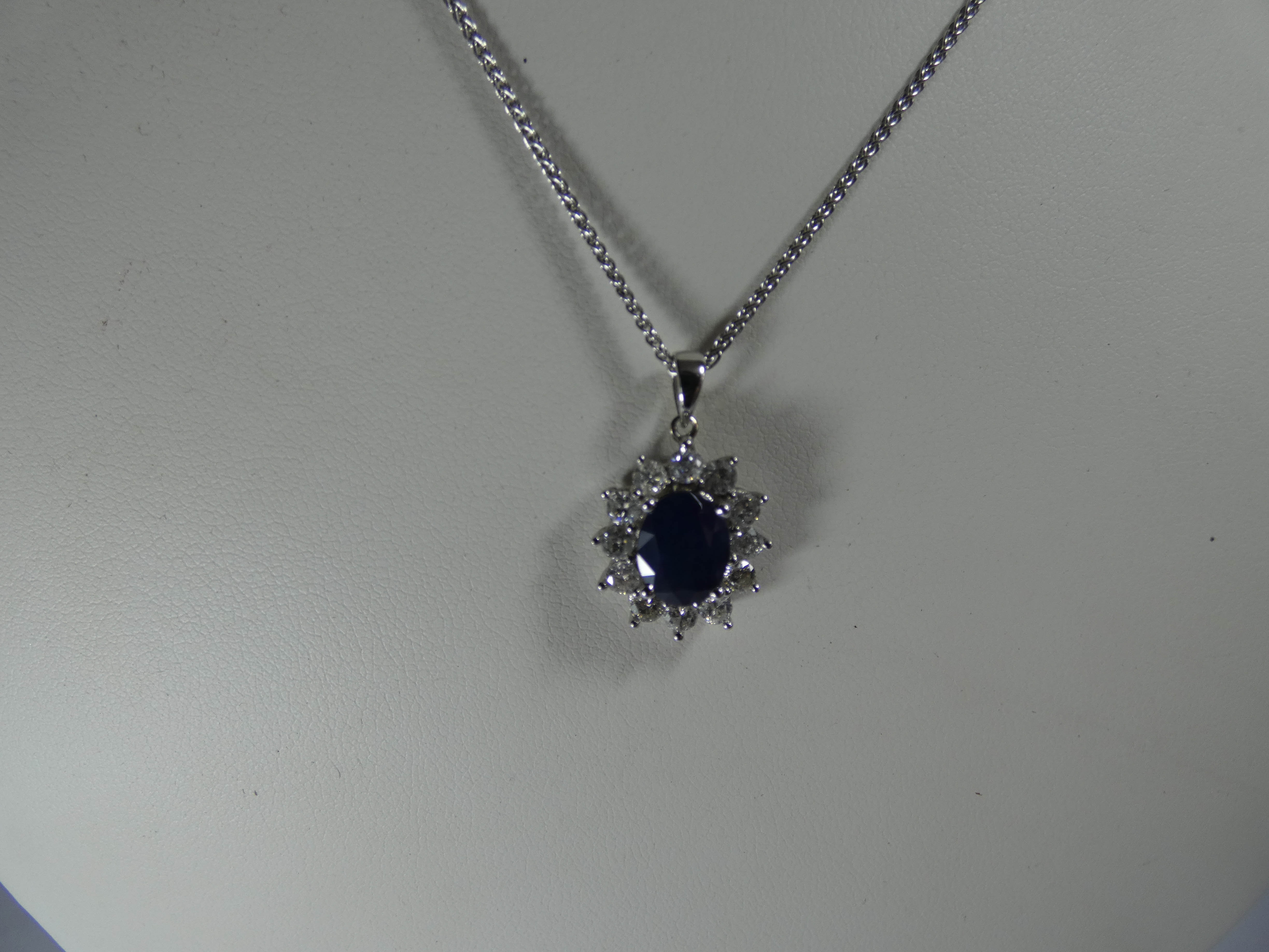 An 18ct white gold sapphire and diamond cluster pendent set with an oval sapphire surrounded by 12 - Image 3 of 3