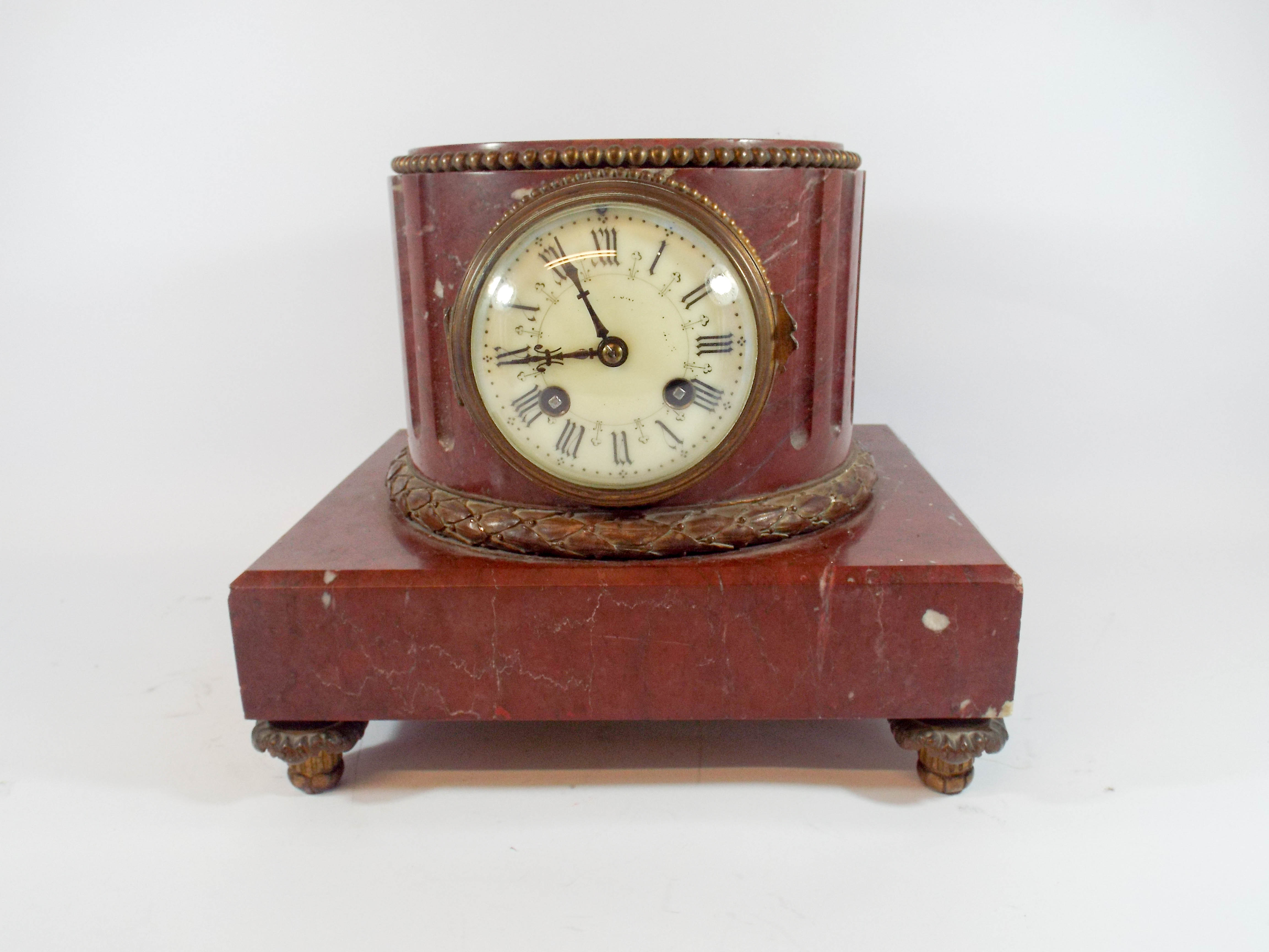 French rouge marble circular clock.