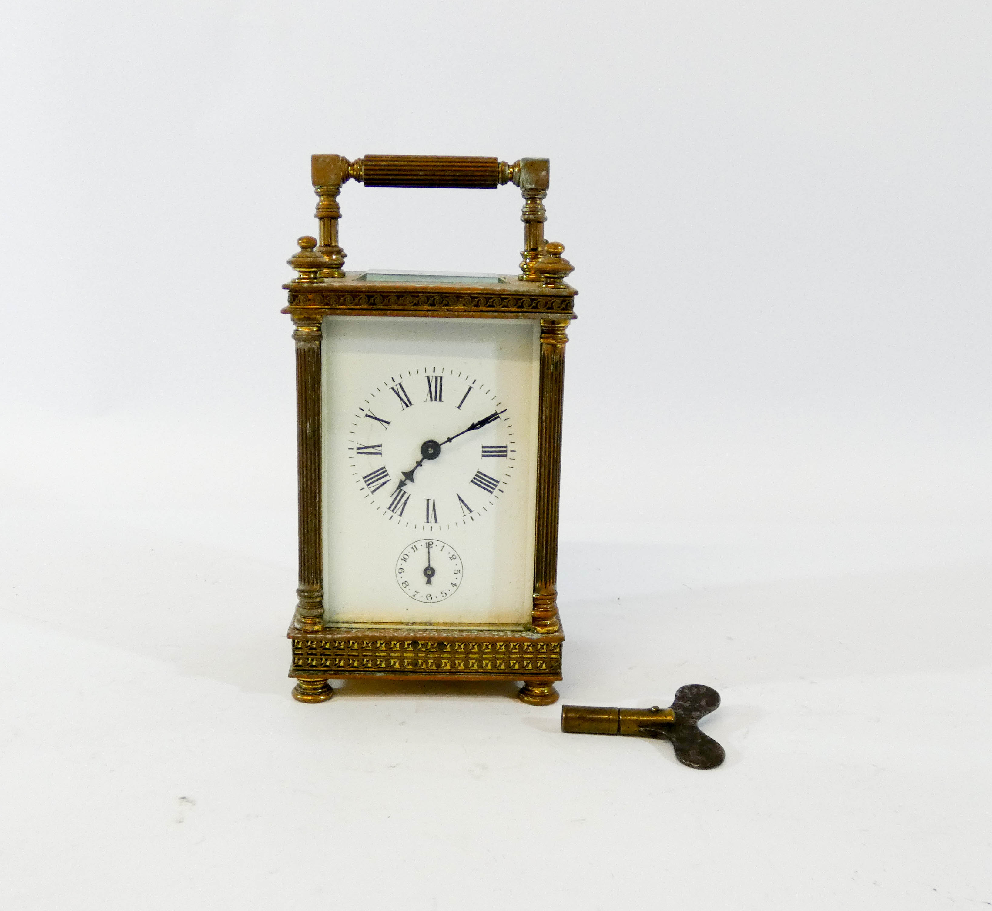 A 19th century brass carriage clock in a classically designed case with columns,