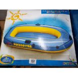 A Intex inflatable dingy and an inflatable paddling pool