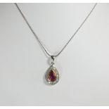 An 18ct white gold ruby and diamond tear drop shape pendent,