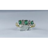 Three stone emerald and diamond half hoop ring, early 20th century, marked 18ct & Plat.