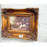 A small Victorian style painting of hunting dogs in decorative gilt frame
