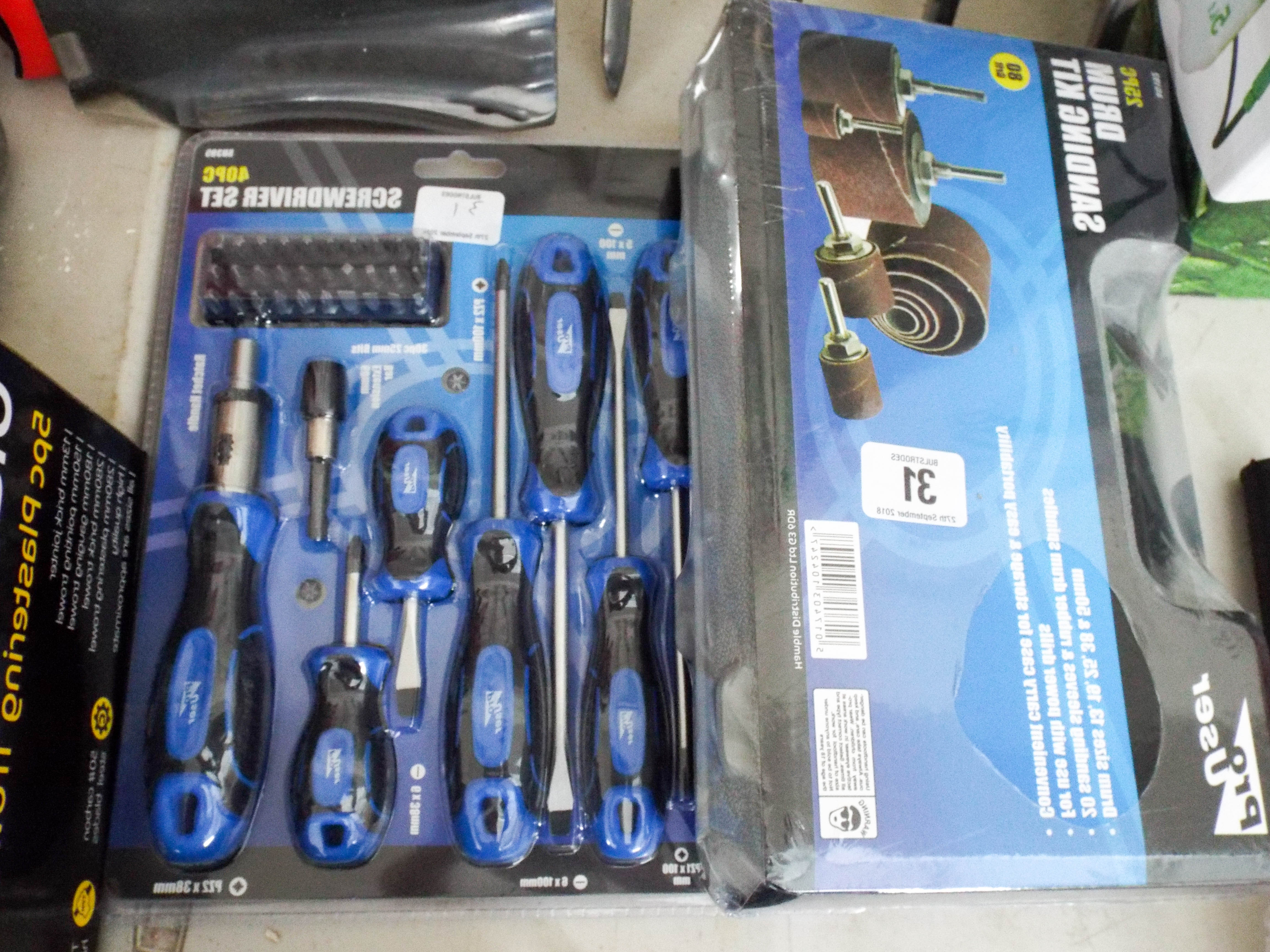 A new 40 piece screw driver set and a new 25 piece drum sanding kit