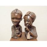 A pair of African carved hardwood busts approx 12" tall