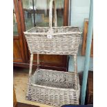 A washed wicker two tier kitchen basket or vegetable rack