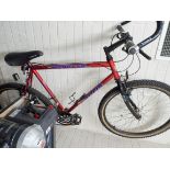 A red Carrera gents bicycle