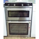 A built in double oven electric cooker in stainless steel case