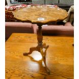 A reproduction walnut wine table on tripod base together with a similar mahogany table