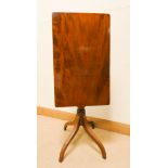 A rectangular polished mahogany occasional table on pillar and quadruple base