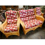 A bamboo and wicker conservatory suite comprising two seater settee and two chairs with red floral
