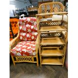 A bamboo conservatory armchair with red floral patterned cushions,