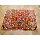 Red and floral patterned Persian rug approx 5' x 3'6