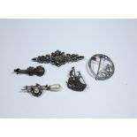 A collection of five silver and marcasite brooches to include a violin shaped example