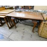 A mahogany coffee table on cabriole legs