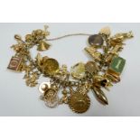 A 9ct yellow gold charm bracelet set with numerous charms,