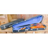 Three various violins in cases