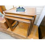 A nest of three 1970's teak coffee tables