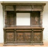 A large 19th century heavily carved oak sideboard with large overhanging corners above a back panel