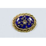 Blue enamel and five cut diamond oval brooch with rope twist border, gross weight 24.