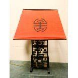 A Chinese Abacus table lamp with orange shade