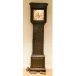A Victorian eight day Grandfather clock in carved dark oak case with square brass and silver dial