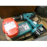 A Makita cordless drill with charger and two batteries