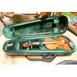 A violin with bow in canvas carrying case