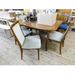 A GPlan teak extending dining table with centre leaf and six matching chairs with pale green