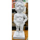 A white garden figure ornaments of a little boy peeing