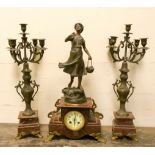 A French three piece clock garniture comprising a striking clock with girl figure mount on a rouge