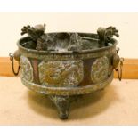 A Victorian decorative copper and brass mounted circular jardiniere standing on paw type feet 16"