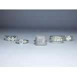 A collection of silver and paste CZ dress rings to include eternity rings and impressive clusters,