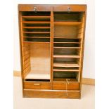 A double door oak shutter front office cabinet with interior shelves 31 1/2" wide,