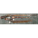 Two old Indian guns, the first a flint lock with octagonal barrel, the stock inlaid with brass,