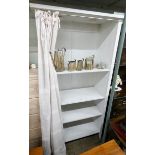 A white painted open shelf unit with curtain 3' wide