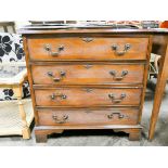 A reproduction mahogany Georgian style chest of four long drawers with cross banded top and brass