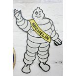 A cast Michelin man wall hanging plaque