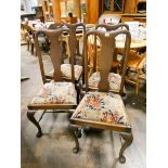 A set of four mahogany high shield back dining room chairs on cabriole legs with cross stretchers