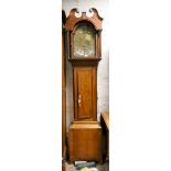 A 19th Century 8 day long case clock in an inlaid mahogany case with brass arched dial,