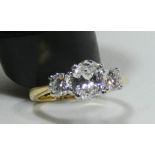 A good diamond three stone ring, the central oval diamond with GIA certificate weighing 59 points,
