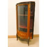 A French style shaped front glazed corner cabinet with marquetry style decoration and gilt metal