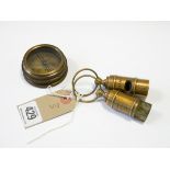Two Titanic brass whistles and a Titanic compass